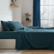 Peacock Blue Linen Fitted Sheet On The Bed