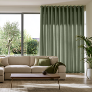 Asparagus Green Linen Grommet Extra Long Curtains in a Contemporary Living Room with Large Sliding Window and Indoor Plants
