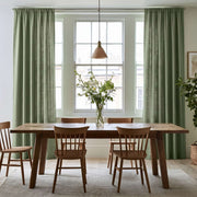 A Dining Room Scene With Asparagus Green Curtains Hanging On Both Sides Of A Large White Window