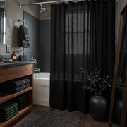 Black Linen Button-Hole Top Shower Curtain in a Modern Bathroom with Gray Plaster Walls and Walnut Vanity