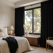 Black Linen Pencil Pleat Curtains in a Soft Beige Bedroom with Light Wood Accents - Blackout Lining