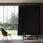 Black Linen Pencil Pleat Extra Long Curtains in a Modern Living Room with Large Glass Doors and Wooden Accents