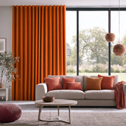 Burnt Orange Linen Back Tab Extra Long Curtains in a Contemporary Living Room with Light Gray Sofa, Orange Accent Pillows and a Round Coffee Table 