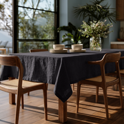 Charcoal Grey Rectangular Linen Tablecloth in a Modern Dining Room with Cane Chairs