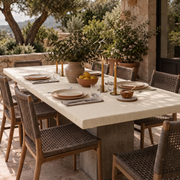 Cream Fitted Rectangular Linen Tablecloth in a Mediterranean Patio Dining Area with Woven Chairs