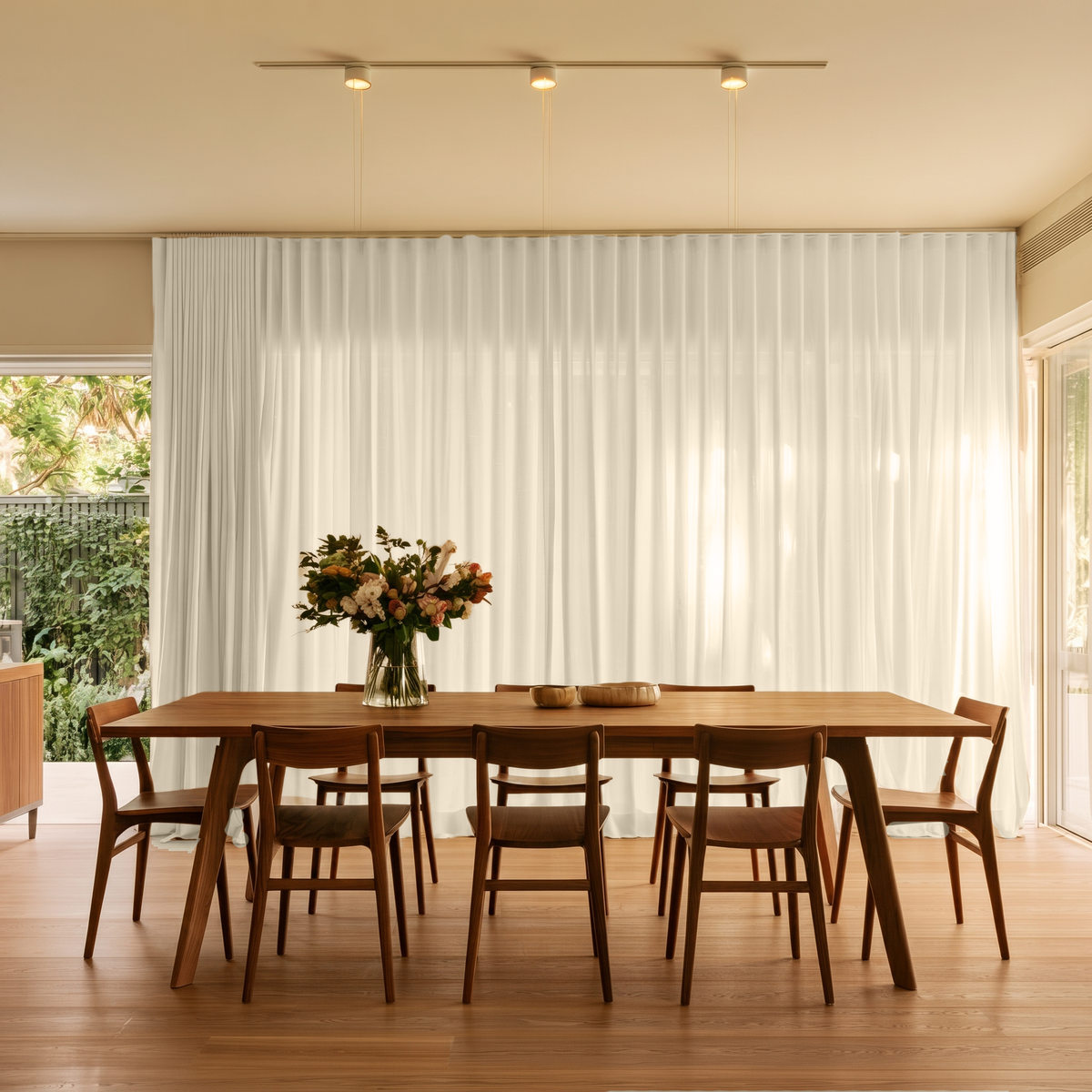 Cream Linen S-Fold Dining Room Curtain in a Modern Dining Room with Beige Walls and a Long Wooden Table Featuring a Floral Centerpiece.