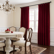 Dark Deep Red Velvet Curtains in a Dining Room with Beige Walls, a White Dining Table, and a Rug