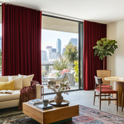 Dark Deep Red Velvet S-Fold Blackout Curtains for Sliding Doors in a Living Room with Cream Walls