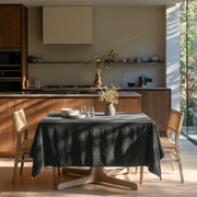 Dark Grey Rectangular Velvet Tablecloth in a Contemporary Kitchen with Walnut Cabinetry and Cane Chairs