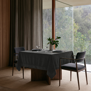 Dark Grey Square Velvet Tablecloth in a Contemporary Dining Room with Floor-to-Ceiling Windows and Wood Paneling