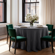 Dim Grey Linen 90 Inch Round Tablecloth in a Bright City Dining Room with White Walls and Emerald Green Velvet Chairs