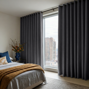 Dim Grey Linen Grommet Curtains in a Bright City Bedroom With Warm Beige Walls - Blackout Lining