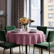 Dusty Rose Linen Round Tablecloth in a Modern City Dining Room with Soft Gray Walls and Emerald Green Velvet Chairs