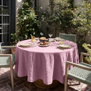 Dusty Rose Linen Round Tablecloth in a Sunlit Patio Dining Space with Sage Green Woven Chairs