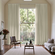 Ecru Heavy Weight Linen S-Fold Extra Long Curtains in a Modern Double-Height Living Room with Minimalist Furniture