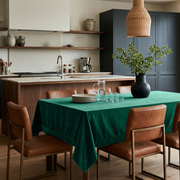 Emerald Green Rectangular Velvet Tablecloth in a Contemporary Kitchen with Navy Cabinetry and Cognac Leather Chairs