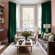 Emerald Green Velvet Pencil Pleat Blackout Curtains in a Living Room with Soft Coral Walls