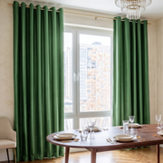 Fern Green Velvet Curtains in a Rich Dining Room with Beige Walls and a Wooden Table, Wooden Chairs with Soft Seats