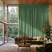 Fern Green Velvet Pencil Pleat Extra Long Curtains in a Modern Living Room with Floor-to-Ceiling Windows and Wood-Paneled Ceiling