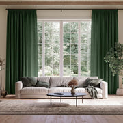 Forest Green Linen Pencil Pleat Extra Long Curtains in a Transitional Living Room with White Sofa, Green Pillows, and a Round Black Coffee Table