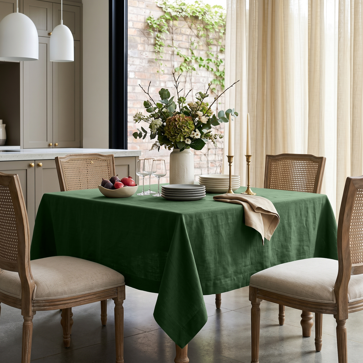 Forest Green Square Linen Tablecloth in a Transitional Dining Room with Cane-Back Chairs and Cream Curtains