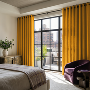Mustard Yellow Linen Grommet Bedroom Curtains in an Elegant Urban Bedroom with Plum Accent Chair and Bronze Accents - Cotton Lining