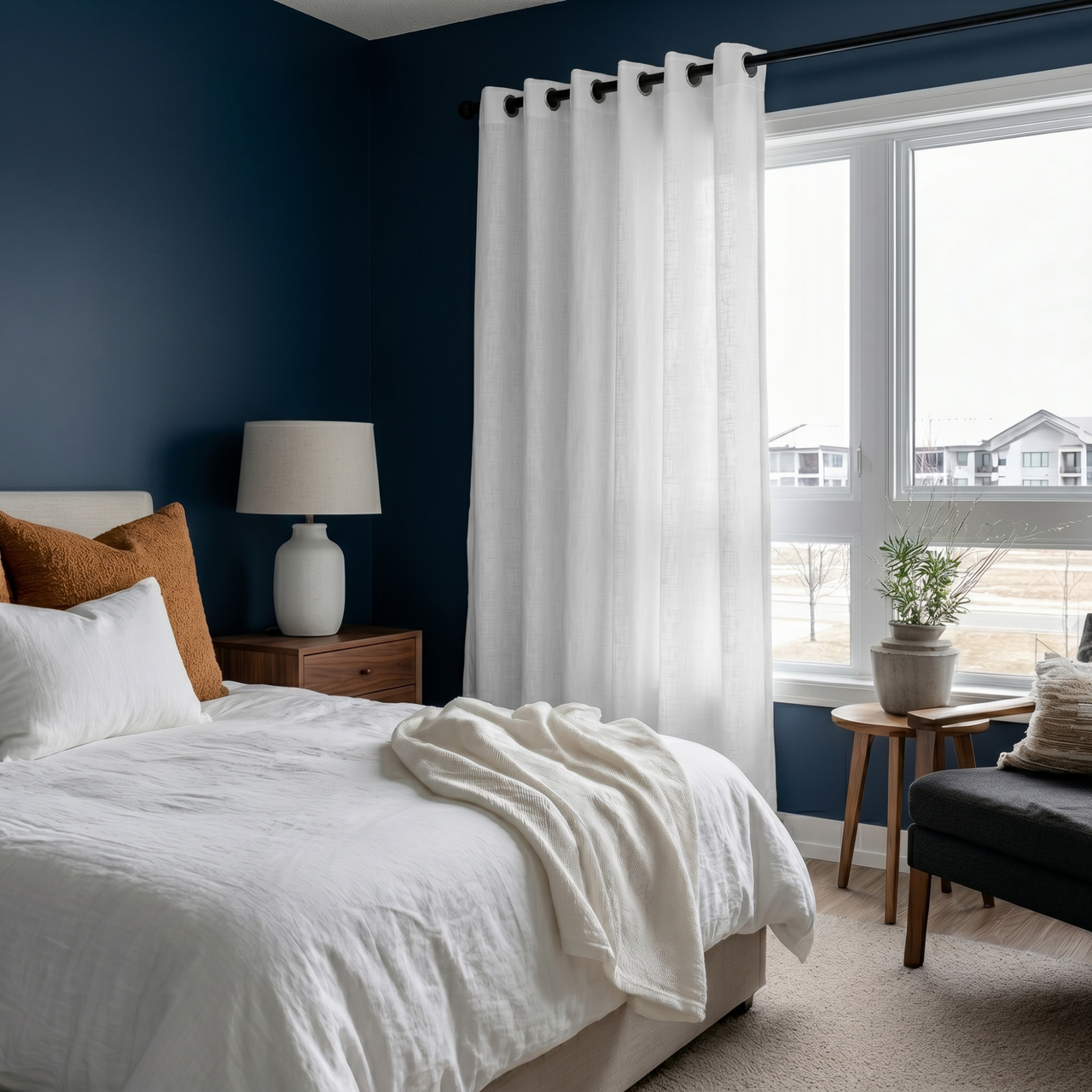 White Linen Grommet Curtains in a Cozy Blue Bedroom With White Bedding and a Large Window