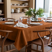 Terracotta Rectangular Heavy Weight Linen Tablecloth in a Mid-Century Modern Dining Room with Walnut Chairs and Open Shelving