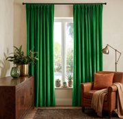Lime Green Velvet Pinch Pleat Curtains in a Cozy Living Room with Beige Walls and a Brown Leather Armchair