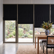 Black Roman Shades in a Dining Room with Blue Stripe Wallpaper and Wooden Dining Table