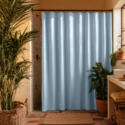 Sky Blue Linen Button-Hole Top Weighted Shower Curtain in a Cozy Boho Bathroom