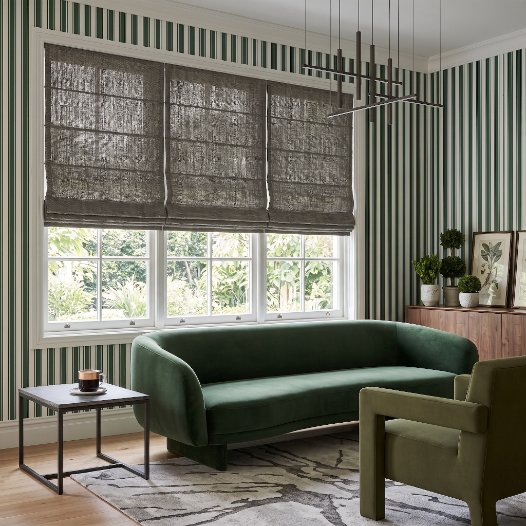 Heavy Natural Roman Shade in a Modern Living Room with Green Striped Wallpaper and a Velvet Sofa