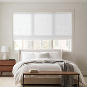 White Linen Cordless Roman Shades in a Modern Bedroom with Off-White Walls and a Wooden Bench