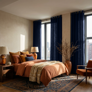 Royal Blue Linen Grommet Curtains in a Cozy Bedroom with Beige Walls and Terracotta Bedding