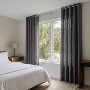 Dim Grey Linen Grommet Curtains in a Minimal Bedroom With Soft Beige Walls and Warm Wood Furniture