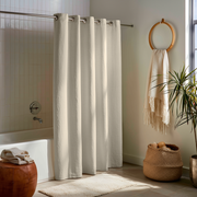 Ecru Heavy Weight Linen Hookless Weighted Shower Curtain near a Round Towel Holder