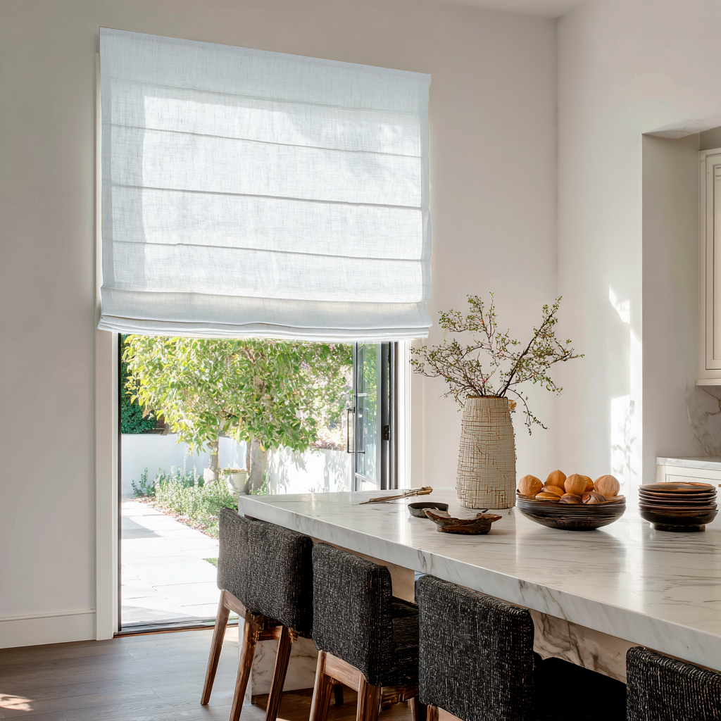 White Linen Kitchen Roman Shades in a Modern Kitchen with White Walls, Marble Island and Woven Chairs