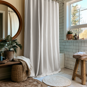 Off-White Heavy Weight Linen Button-Hole Top Weighted Shower Curtain in a Sunlit Bathroom near a Round Mirror