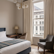 Cream Linen Pencil Pleat Curtains in a Classic Contemporary Bedroom with Elegant Lighting - Blackout Lining