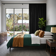 Black Linen Pencil Pleat Curtains in a Crisp White Bedroom with Deep Green Accents 