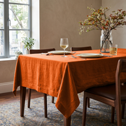 Burnt Orange Rectangular Linen Tablecloth in a Warm Contemporary Dining Room with Walnut Chairs