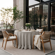 Natural Linen Round Ruffle Tablecloth in a Sunlit Patio Dining Space with Cream Upholstery
