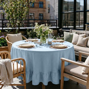 Sky Blue Linen Round Ruffle Tablecloth in an Outdoor Patio Dining Space with Light Wood