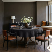 Charcoal Grey Linen Round Tablecloth in a Dining Room with Dark Taupe Walls and Caramel Leather Chairs