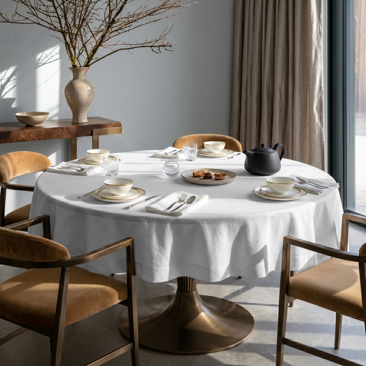 White Linen Round Tablecloth in an Elegant Dining Room with Soft Gray Walls and Camel Velvet Chairs