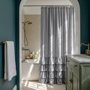 Stone Grey Linen Ruffle Shower Curtain in a Classic Bathroom with Deep Teal Walls and Sage Green Accents