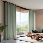 Mint Green Velvet Grommet Blackout Curtains for Sliding Doors in a Living Room with Beige Walls