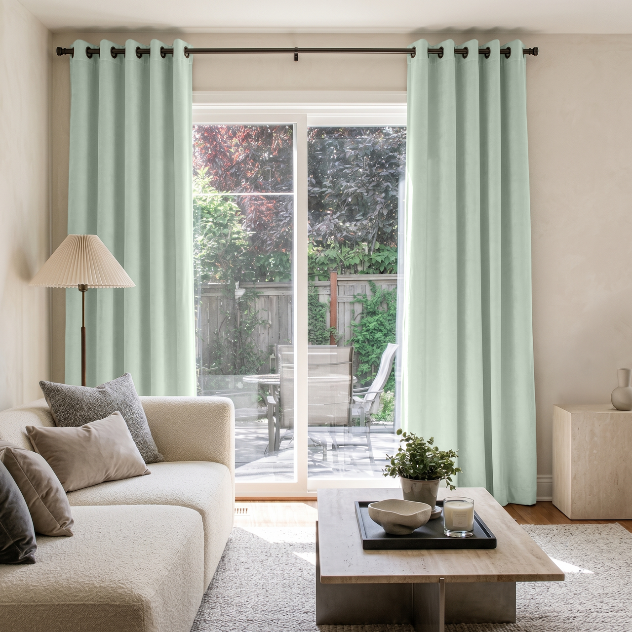 Mint Green Velvet Grommet Sliding Patio Door Curtains in a Minimal Living Room with a Cream Sofa and a Travertine Coffee Table