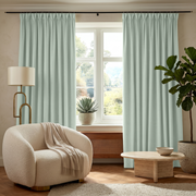 Mint Green Velvet Pinch Pleat Curtains in a Minimal Sitting Room with a Cream Bouclé Chair and a Brass Floor Lamp