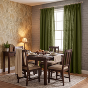 Moss Green Linen Pinch Pleat Curtains in a Cozy Traditional Dining Room with Brick Accent Wall and Dark Wood Furniture